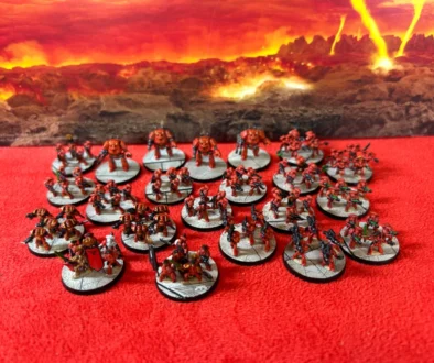 Photo of a Legions Imperialis Blood Angels Space Marine Demi-Company on a red field against a volcanic backdrop.
