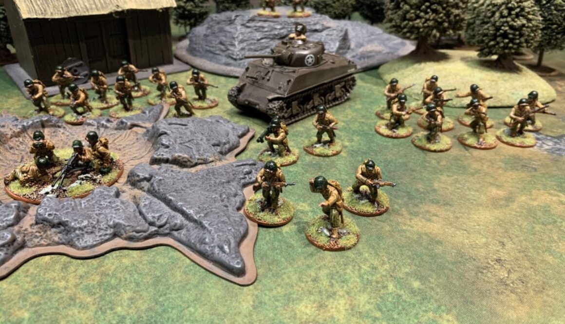 Photo of an approximately 650 point force of American Bolt Action miniatures with a farmhouse, forest, rock, and crater I the background.