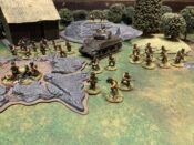Photo of an approximately 650 point force of American Bolt Action miniatures with a farmhouse, forest, rock, and crater I the background.